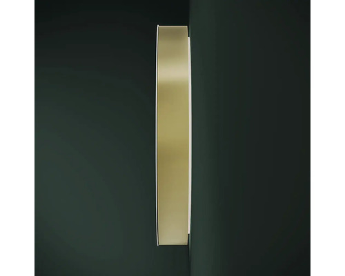 Ronde spiegel met metalen frame aan de muur