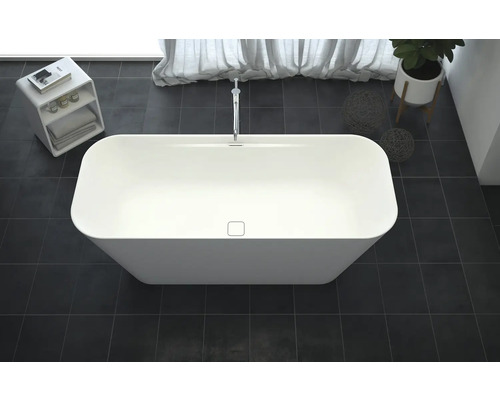 Vrijstaand bad in de badkamer met kraan, plant en opbergrek