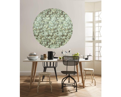 Eetkamer met eettafel, stoelen en ronde wanddecoratie met plantenpatroon