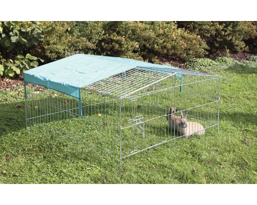 Buitenhok met zonwering en konijnen op een gazon