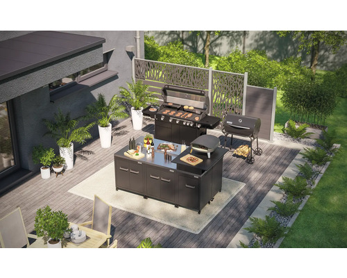 Terras met buitenkeuken, gasbarbecue, houtskoolbarbecue en pizzaoven in een tuin.