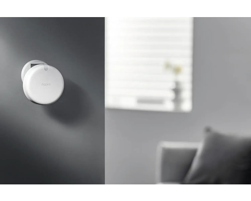 Aqara logo op een rond, aan de muur gemonteerd apparaat