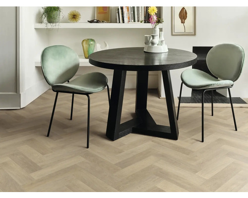 Interieurweergave van een eetkamer met een ronde eettafel, twee stoelen en een lichte houten vloer in visgraatmotief