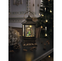 Decoratieve lantaarn met sneeuwbol en figurenpaar op tafel met kerstdecoratie