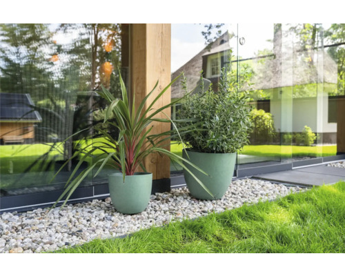 Twee groene plantenbakken met planten in de tuin.