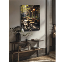 Wanddecoratie met caféscènes boven een console in de woonkamer
