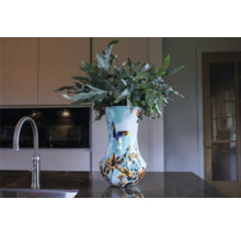 Decoratieve vaas met planten op een aanrecht