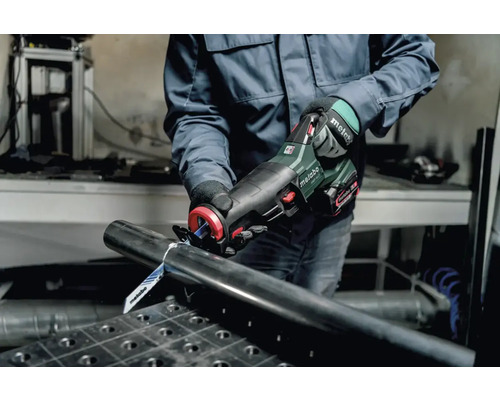 Een persoon snijdt een metalen buis door met een Metabo reciprozaag.