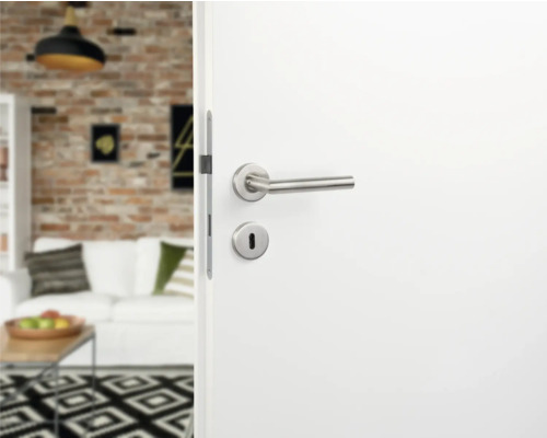 Witte binnendeur met zilverkleurige deurklink en slot in een moderne woonkamer