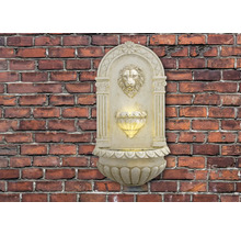 Muurfontein met leeuwenkop en verlichting voor een bakstenen muur