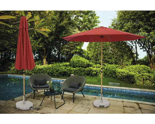 Scène met twee tuinstoelen, een klein tafeltje, een open en een gesloten parasol naast een zwembad