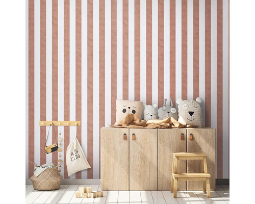 Kinderkamer met gestreept behang, houten kast en decoratieve knuffels.