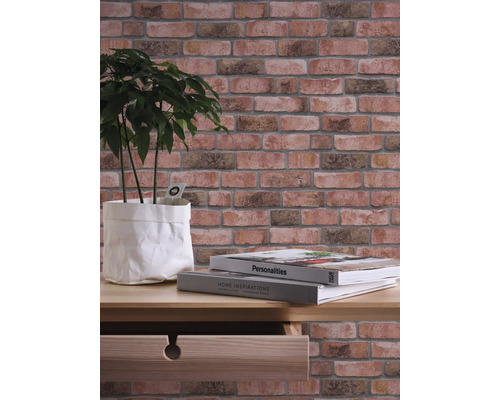 Wanddecoratie met steenlookbehang, plant en boeken op een tafel