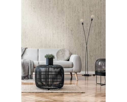 Woonkamer met beige structuurbehang, bank en zwarte rotan tafel