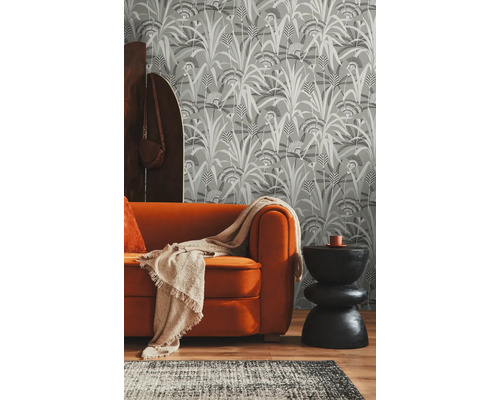 Woonkamer met patroonbehang, bank en vloerkleed