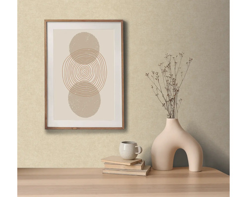 Decoratieve scène met een ingelijst abstract kunstwerk, een vaas met bloemen, boeken en een kopje op een tafel.