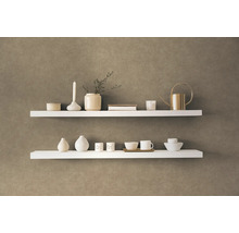 Twee witte planken met decoratieve items aan een muur