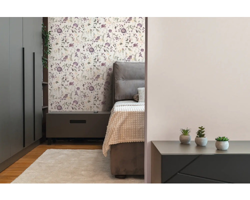 Slaapkamer met bed, nachtkastje, kledingkast en bloemenbehang