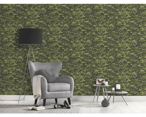 Woonkamer met mosbehang, fauteuil, staande lamp en bijzettafels