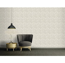 Woonkamer met behang met patroon, fauteuil, bijzettafel en hanglamp