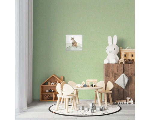Kinderkamer met een wanddecoratie van een lynx, tafel en stoelen