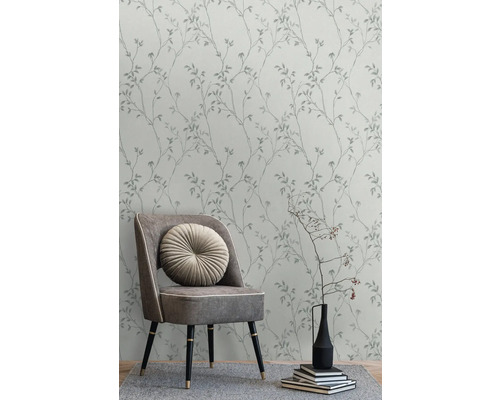 Behang met bladerdesign in interieur met stoel, kussen en decoratie