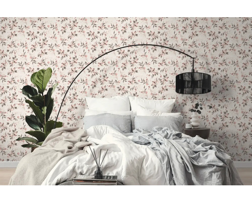 Slaapkamer met bed voor een muur met bloemenbehang