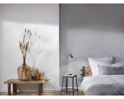 Lichte slaapkamer met houten bed, tafellamp en decoratie