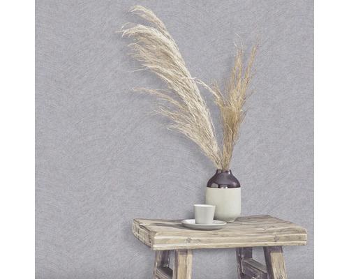 Scene met grijs gestructureerd behang, vaas met siergras, kop en kleine houten tafel