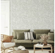 Woonkamer met behang met bloemmotief, bank en fauteuil