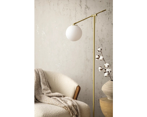 Scene met vloerlamp, fauteuil, wollen deken en katoenen tak in vaas