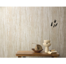 Close-up van een gedecoreerde wand met beige vliesbehang in travertinlook