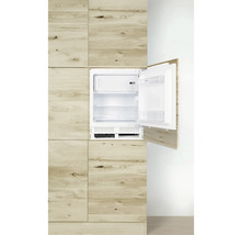 Geïntegreerde koelkast met open deur in een houten keuken