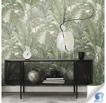 Een woonkamer met een zwarte console en een muur met bloemenbehang.