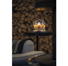 Decoratief peperkoekhuis met verlichting op een tafel