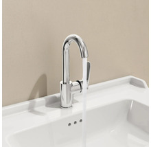 Verchroomde kraan op een witte wastafel met stromend water