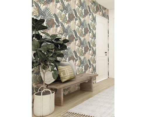 Decoratief behang met bladerpatroon achter houten kruk met kussens en kamerplant in gevlochten mand