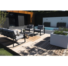 Tuinmeubelset op houten terras naast zwembad en huis