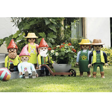 Tuinscène met Playmobilfiguren, waaronder tuinkabouters en tuinmannen met een kruiwagen en een bloembak