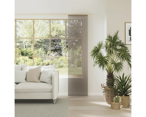 Lichte woonkamer met raam, bank en schuifgordijn ter decoratie en als privacyscherm.