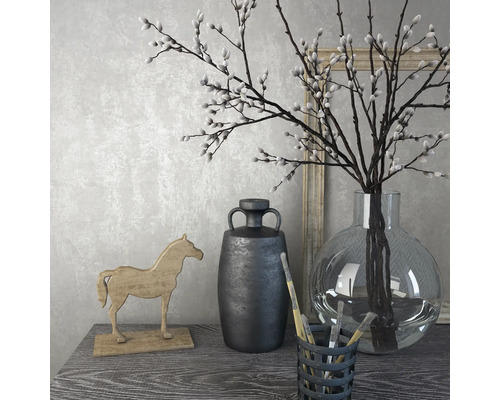 Decoratief stilleven met vaas, takken, houten paard en kan op een tafel.