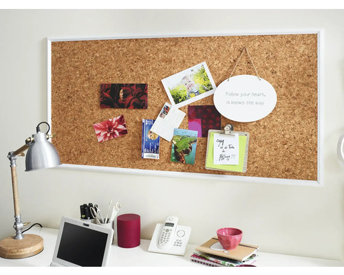 Decoratieve bureauopstelling met prikbord, bureaulamp en kantoorbenodigdheden.