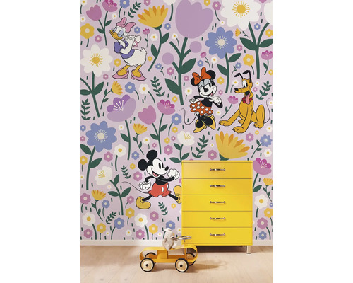 Behang met Mickey Mouse, Minnie Mouse, Donald Duck, Goofy en bloemenpatroon in een kinderkamer met gele commode en speelgoedauto