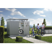 Familie met fietsen voor een tuinhuis met planken