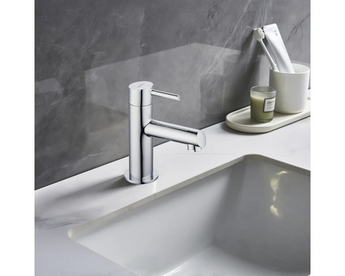 Glanzende kraan op een wastafel in de badkamer