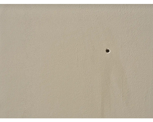 Close-up van een muur met een boorgat