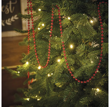 Versierde kerstboom met rode kralenketting en verlichting