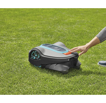 Gardena robotmaaier op gazon met hand op stopknop