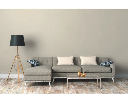 Woonkamer met grijze hoekbank, vloerlamp en salontafel