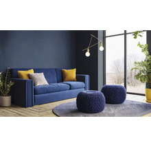Woonkamer met blauwe bank, sierkussens, ronde hockers en kamerplanten